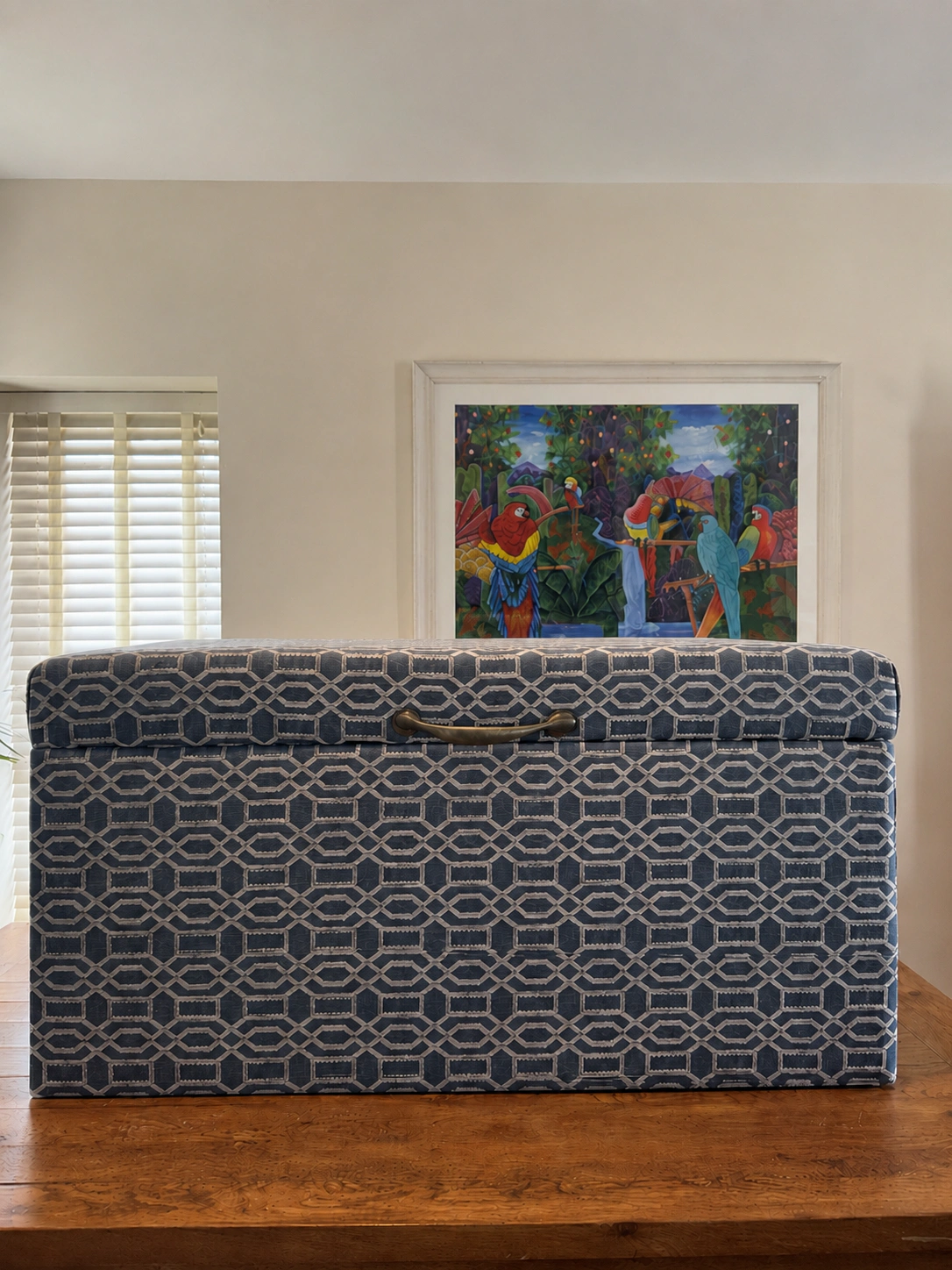 The Achill Storage Ottoman, Upholstered storage ottoman in blue geometric fabric with an antique brass handle